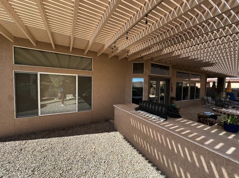 Screened patio panels cleaned under a pergola in Sun City
