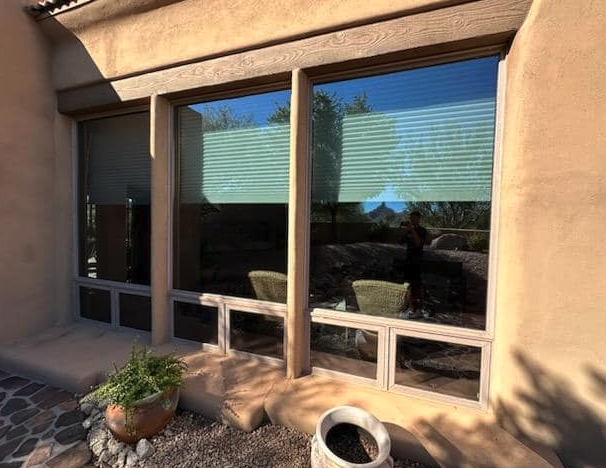 Stucco-framed window screens cleaned on a desert patio