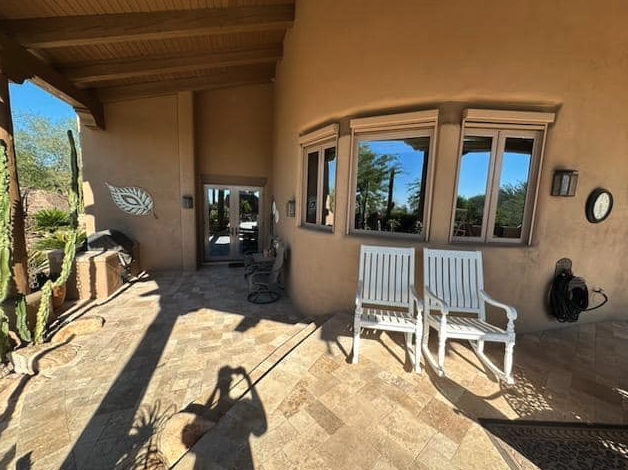 Bay window screens cleaned on a Southwestern-style stucco home