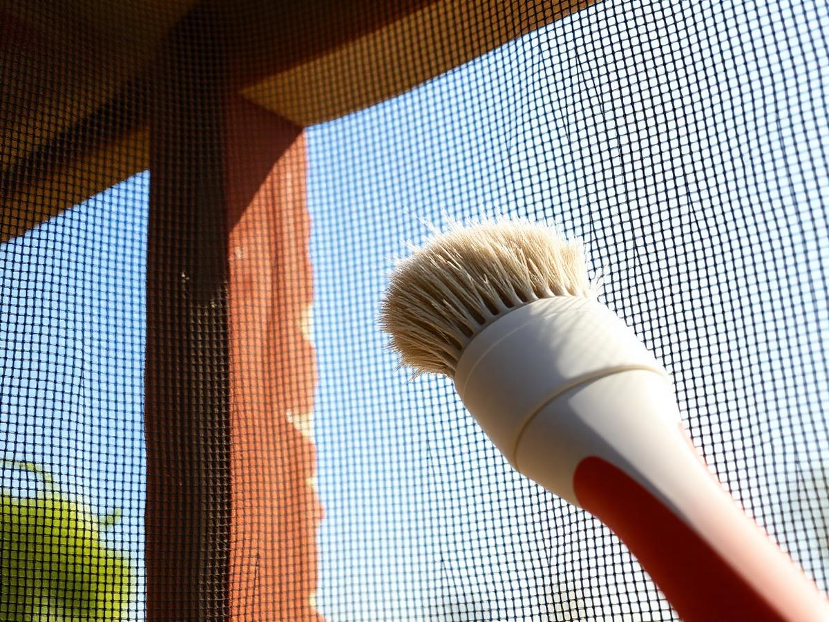 Sun screen mesh being brushed clean of Arizona dust